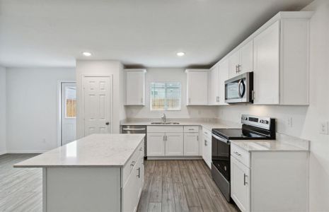 Spacious kitchen with oversized island *real home pictured