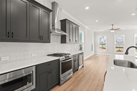 The spacious kitchen is a standout feature, designed with the home chef in mind. It includes high-end stainless steel appliances, sleek countertops, ample cabinetry for storage, and a large center island that serves as the perfect spot for casual dining