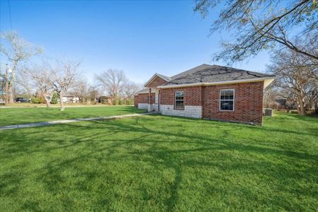 View of property exterior featuring a lawn