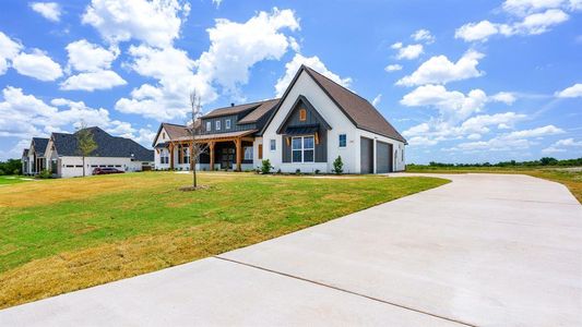 View of front of home featuring a front lawn and a garage