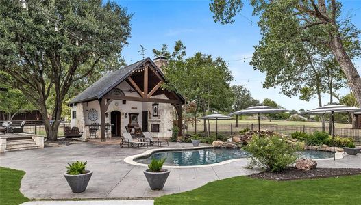 View of swimming pool with a gazebo, a patio area, and an outdoor fireplace