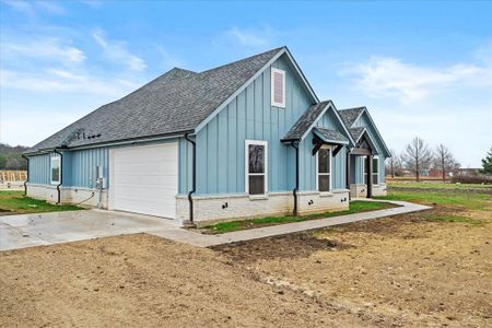 View of side of property with a garage