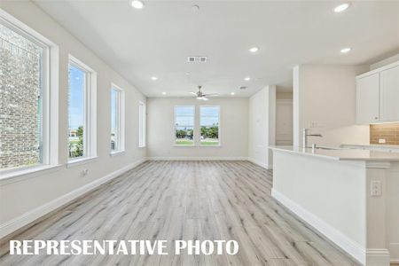 Light, bright and airy, this open concept kitchen-dining-family room is everything you have been searching for in a look and leave lifestyle home!  REPRESENTATIVE PHOTO