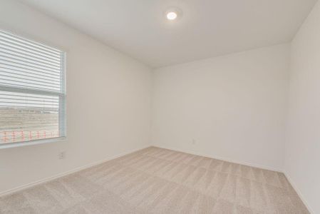 Spare room featuring light colored carpet and baseboards