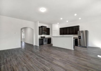 Open-concept layout with the living room opening up to the kitchen and dining room.