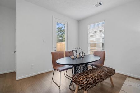 Start your day off right with a cup of coffee sitting with your family in the lovely breakfast/dining area! Featuring large window with privacy blinds, custom neutral paint, vinyl plank flooring, recessed lighting and high ceilings!