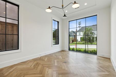 Office featuring a notable chandelier and light parquet floors