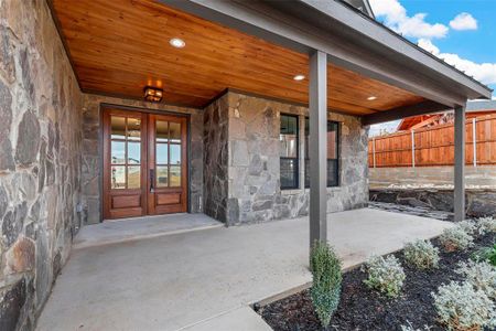 Entrance to property featuring a patio area and french doors