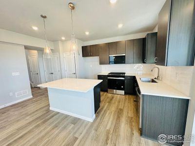 Undermount kitchen sink and contemporary lighting are the perfect accents for this functional kitchen