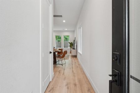 A view of your entryway that unveils small details of your new home inviting exploration with hints of architectural design throughout the home.