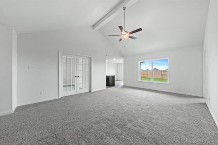 Unfurnished living room featuring beamed ceiling, carpet flooring, high vaulted ceiling, and ceiling fan