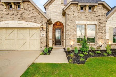 View of front of house with a garage and a front lawn