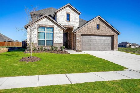 View of front of home featuring a front yard and a garage