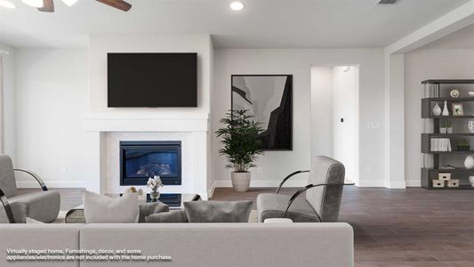 Living room featuring dark hardwood / wood-style flooring and ceiling fan