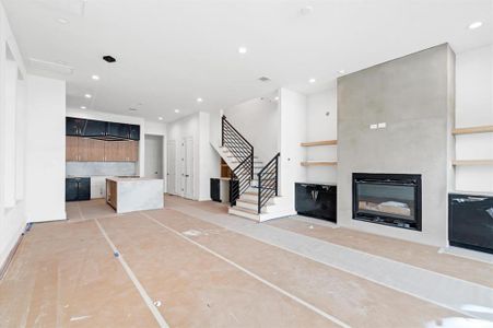 Spacious living area with fireplace that opens to the kitchen.