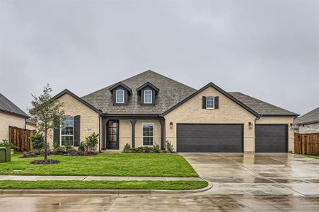 French country home featuring a front yard