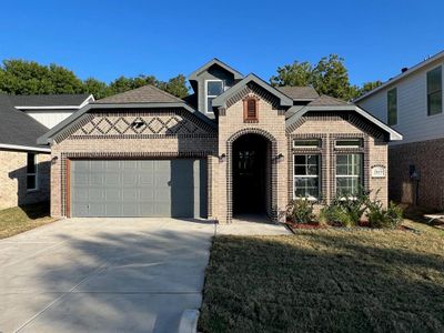 View of front of house featuring a garage and a front yard