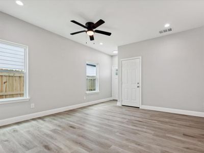 Unfurnished room with ceiling fan and light hardwood / wood-style floors