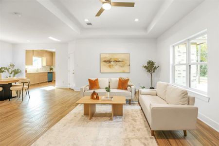 The open-concept living area, with tile flooring throughout, is flooded with natural light, creating a welcoming space for relaxation and socializing.