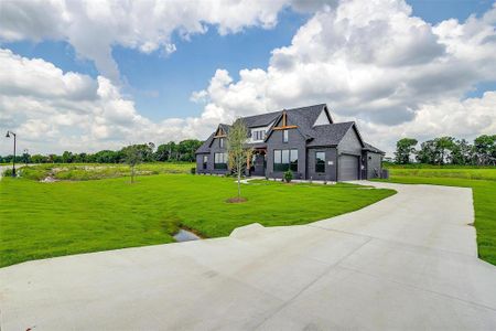 View of front facade with a front lawn and a garage