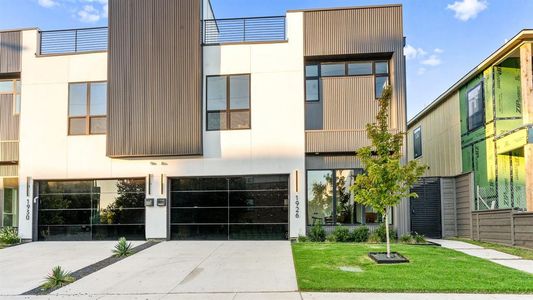 View of front of home featuring a garage and a front yard