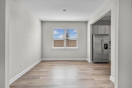 The dining room is adjacent to the kitchen and opens into the living room.