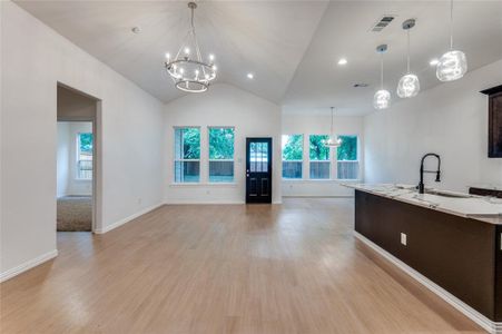 Kitchen featuring pendant lighting, a notable chandelier, sink, and light wood-type flooring