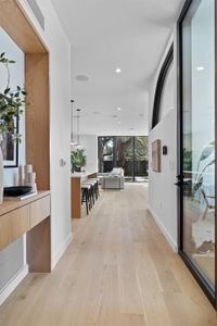 Looking right past the front entry door toward the kitchen and great room