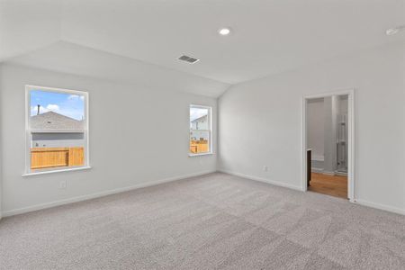 Carpeted bedroom featuring lofted ceiling