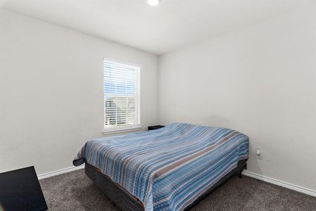Carpeted bedroom featuring baseboards Carpeted bedroom featuring baseboards