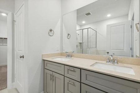 Bathroom featuring vanity and an enclosed shower