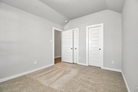 At the forefront of the home, a guest suite with its own bathroom awaits. Sample photo of completed home with similar floor plan. Actual colors and selections may vary.