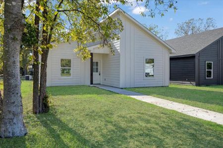 Back of property featuring a lawn and central AC