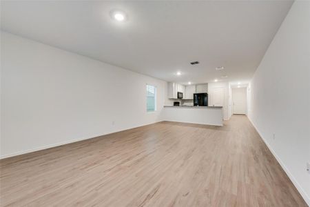 Unfurnished living room with light hardwood / wood-style floors