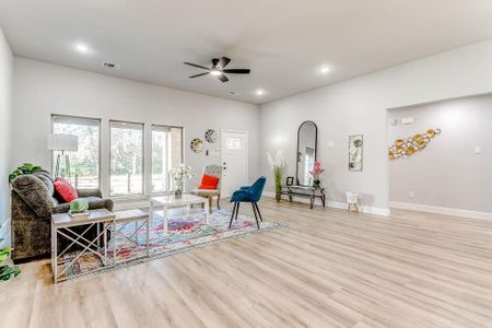 Living room featuring ceiling fan and light wood-type flooring