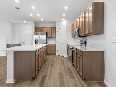 Your spacious kitchen includes quartz counters, 36-inch cabinets, Samsung appliances, and a walk-in pantry.