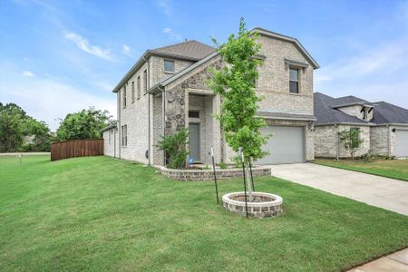 View of front of property with a front lawn and a garage