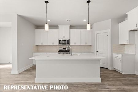 Your new kitchen features a spacious island perfect for friends and family to gather round.  REPRESENTATIVE PHOTO