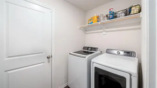 Washroom featuring washing machine and dryer