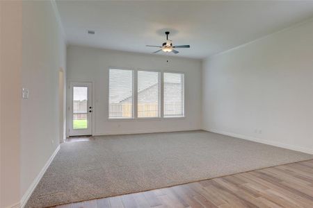 Unfurnished room with ceiling fan and light hardwood / wood-style flooring