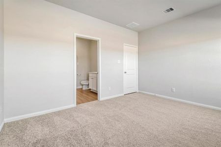 The primary bedroom is the perfect place to relax after a long day.