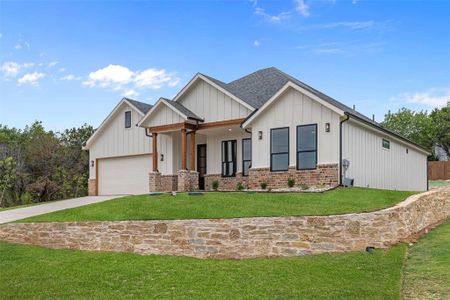 View of front of home featuring a garage and a front yard