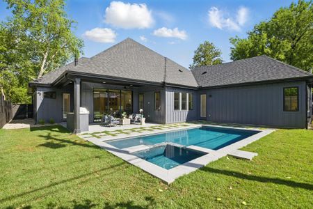 Rear view of property with a shingled roof, board and batten siding, outdoor lounge area, a patio area, and a pool with connected hot tub Rear view of property with a shingled roof, board and batten siding, outdoor lounge area, a patio area, and a pool with connected hot tub
