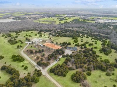 Birds eye view of property with a water view and a rural view