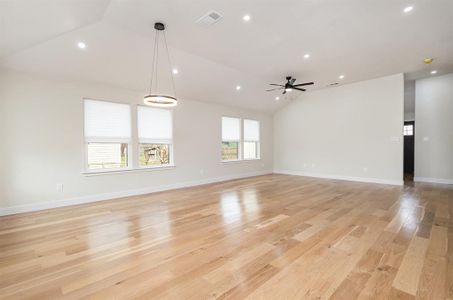 Unfurnished living room with visible vents, recessed lighting, light wood finished floors, ceiling fan, and vaulted ceiling