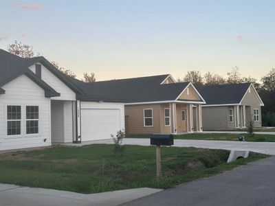 Ranch-style house with a yard and a garage