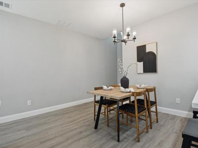 Dining space featuring hardwood / wood-style flooring and a notable chandelier