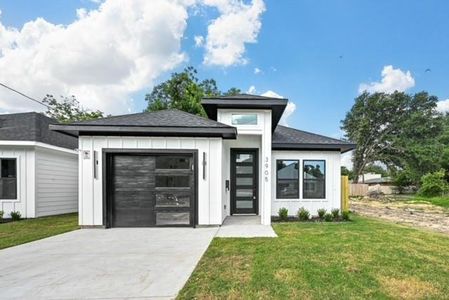 Prairie-style home featuring a front yard and a garage