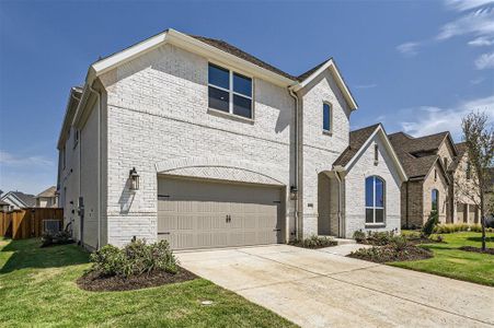 View of front of home featuring a garage, central AC, and a front lawn