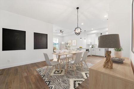 The dining area features a charming accent wall with black details and is adorned with a stylish chandelier. (Virtually staged)